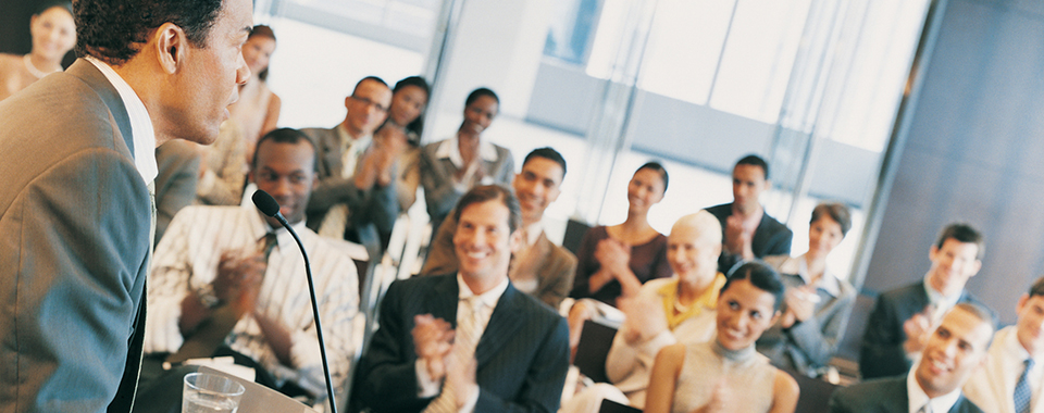 group of people in a meeting clap for speaker